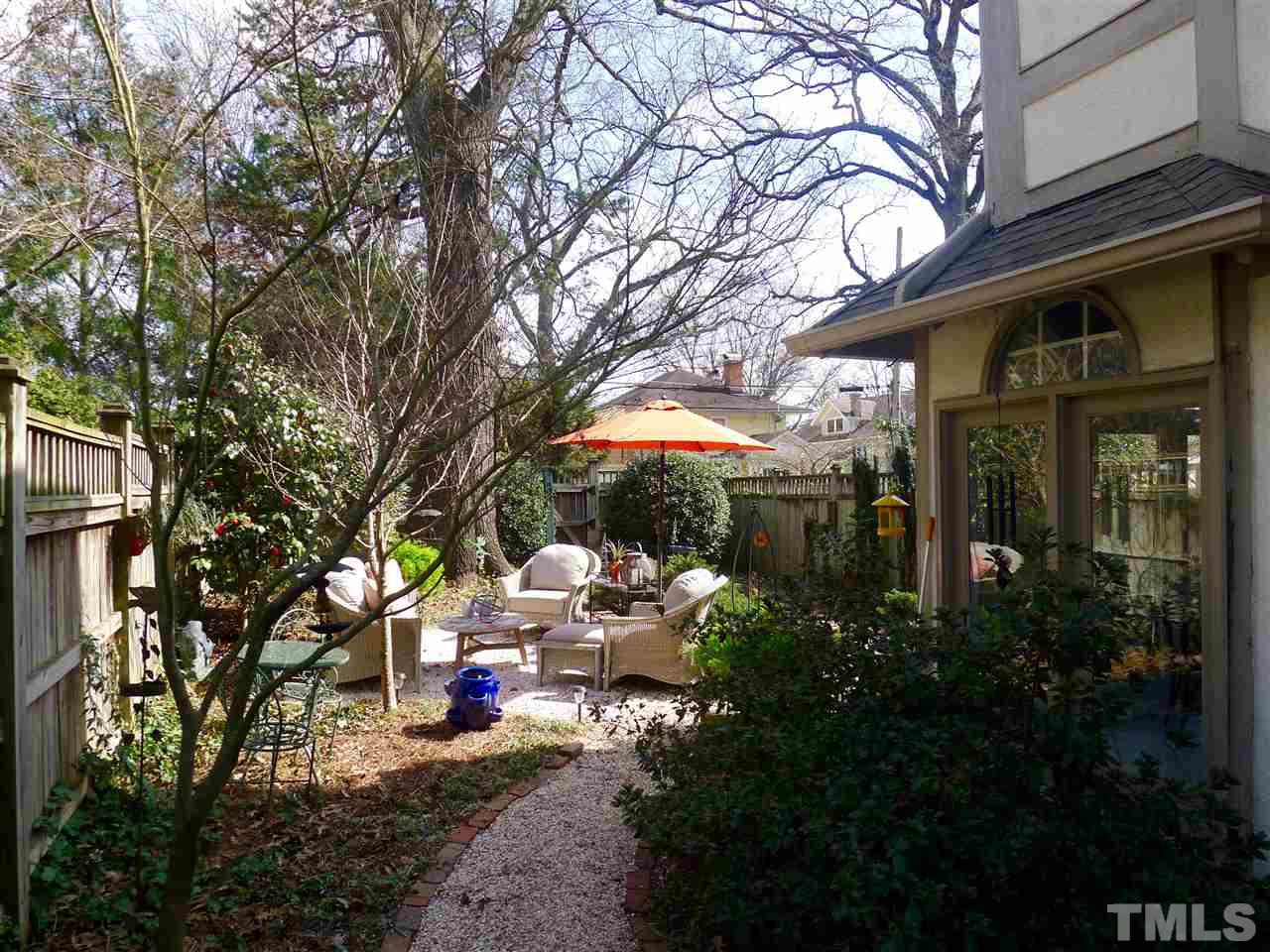 136 Woodburn Road, Unit 4 Raleigh, NC 27605 - Photo 17 of 18 a view of a chair and tables in the patio