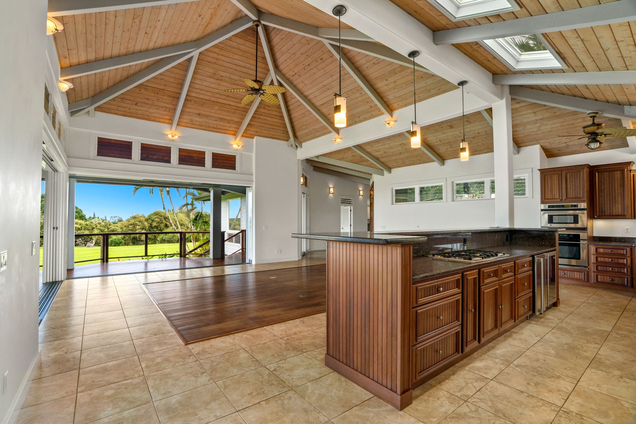4928 Wailapa Road, Unit A Kilauea, HI 96754 - Photo 21 of 30 a view of a kitchen with a sink and dishwasher a stove top oven with wooden floor