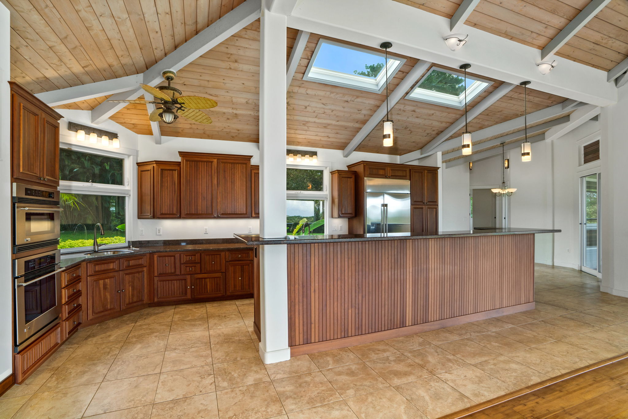 4928 Wailapa Road, Unit A Kilauea, HI 96754 - Photo 3 of 30 a kitchen with stainless steel appliances granite countertop a refrigerator and a stove