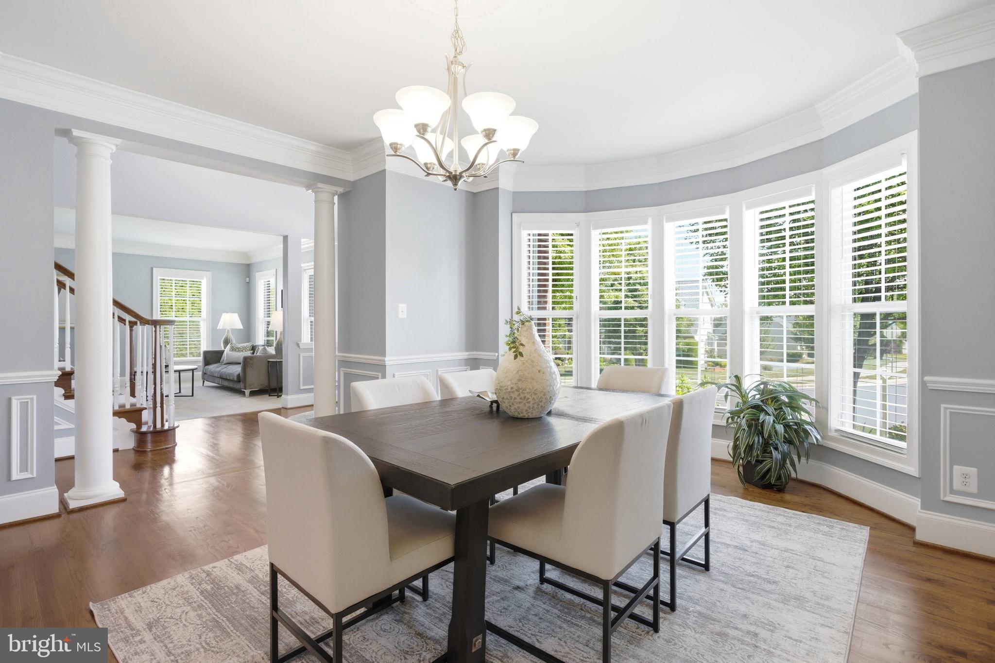 18475 Kerill Road Triangle, VA 22172 - Photo 62 of 99 a view of a dining room with furniture wooden floor and chandelier