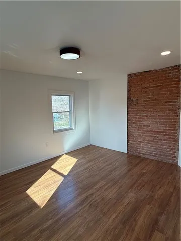 an empty room with wooden floor