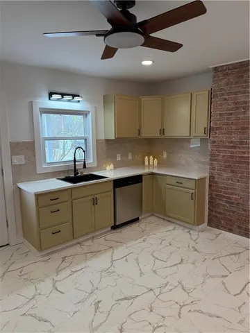 a kitchen with a sink cabinets and window