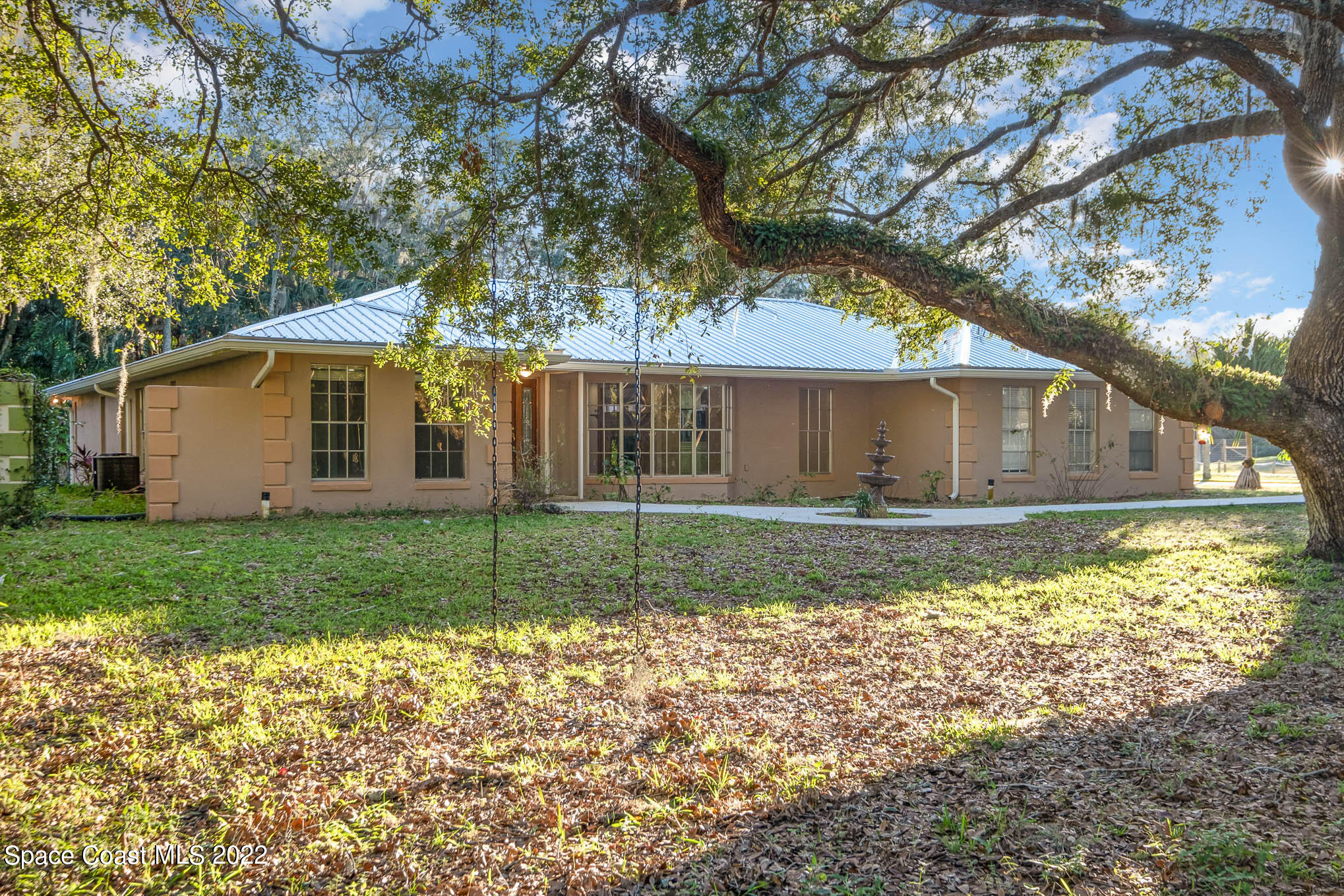 395 East Hall Road Merritt Island, FL 32953 - Photo 12 of 46 a view of a house with yard and a garden