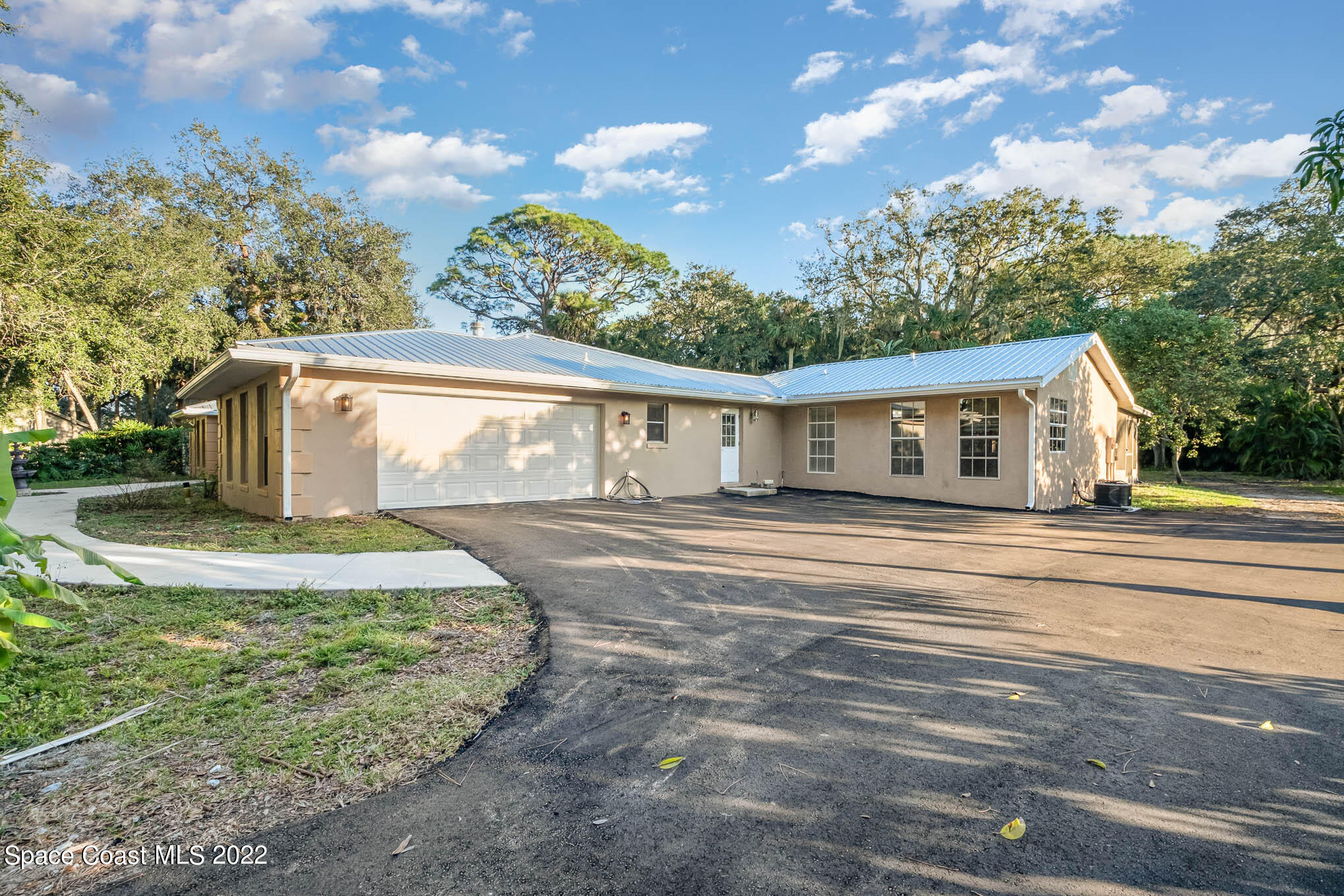 395 East Hall Road Merritt Island, FL 32953 - Photo 13 of 46 a front view of a house with a garden