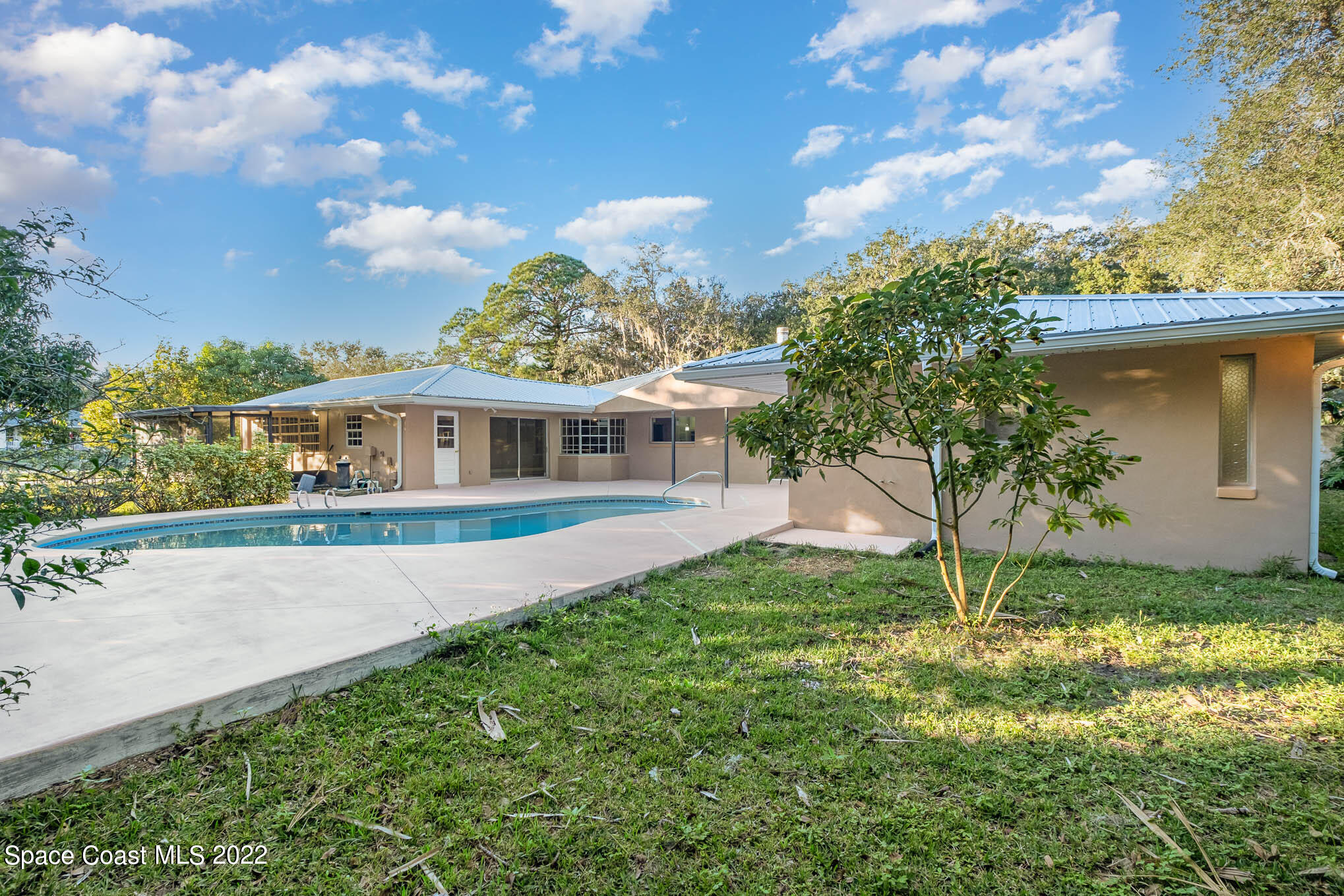 395 East Hall Road Merritt Island, FL 32953 - Photo 14 of 46 a front view of a house with a yard