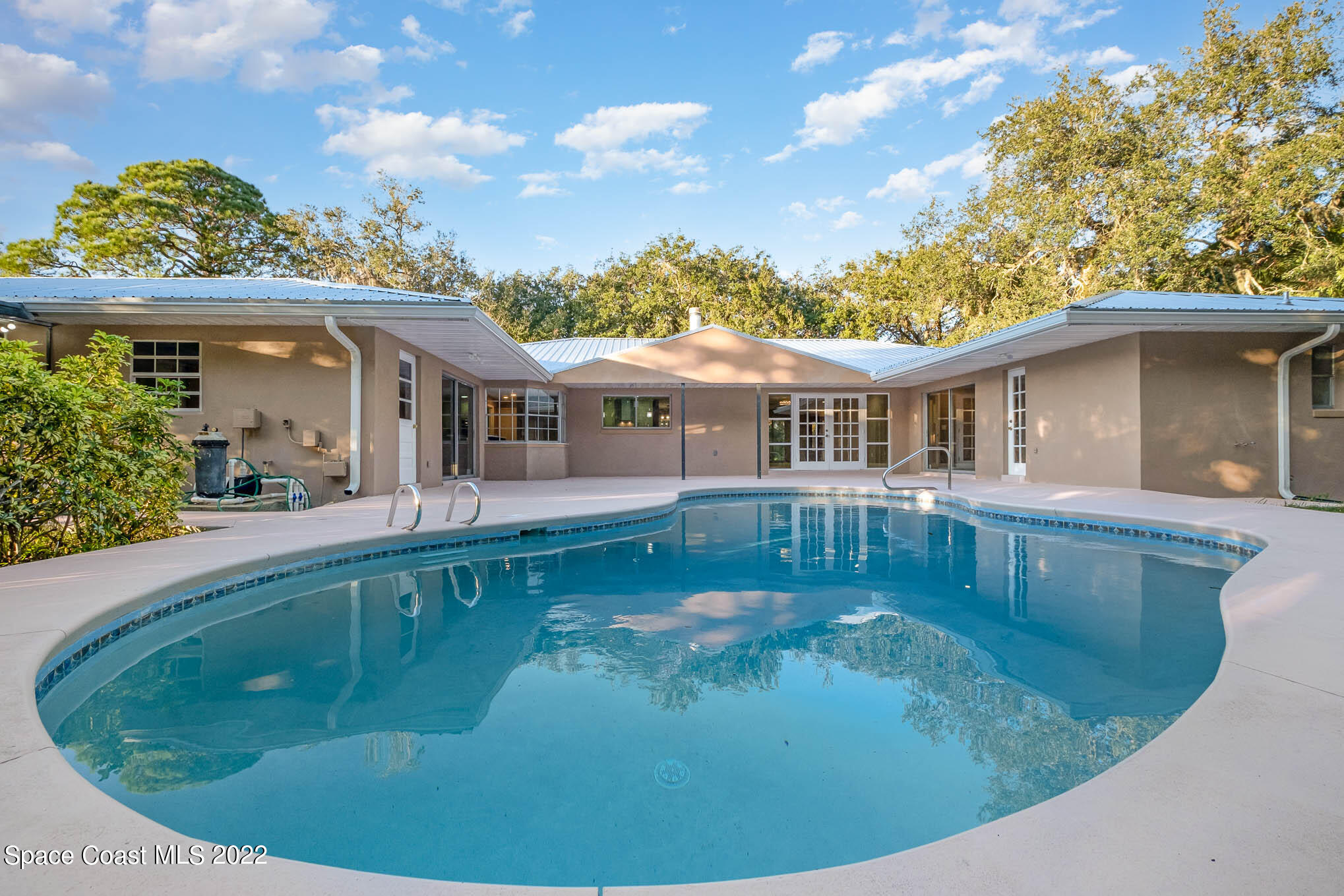 395 East Hall Road Merritt Island, FL 32953 - Photo 15 of 46 a view of a house with roof deck and sitting area