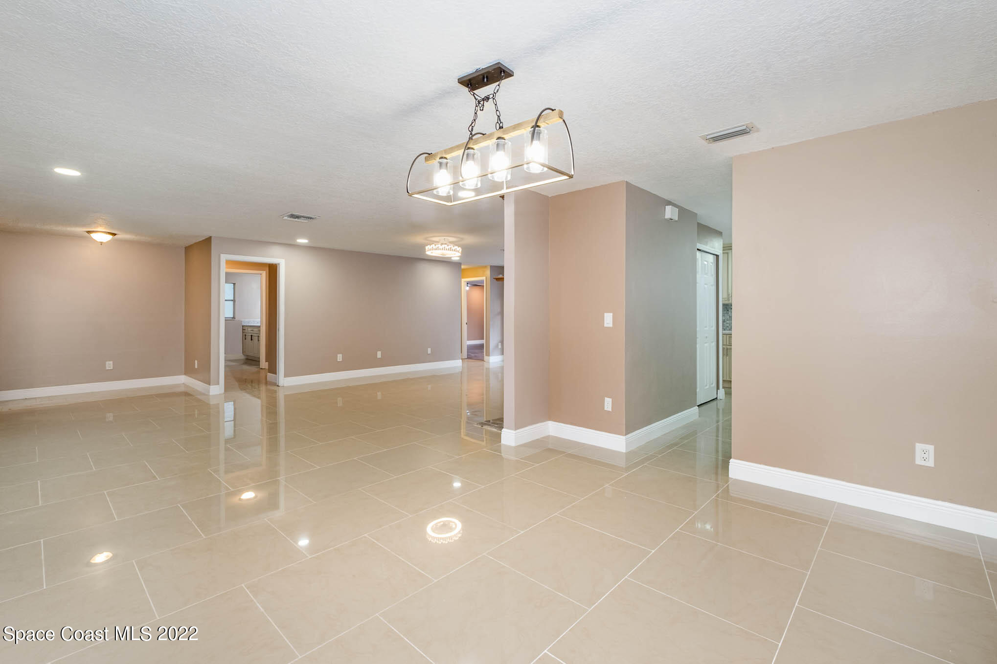 395 East Hall Road Merritt Island, FL 32953 - Photo 20 of 46 a view of an empty room with a kitchen