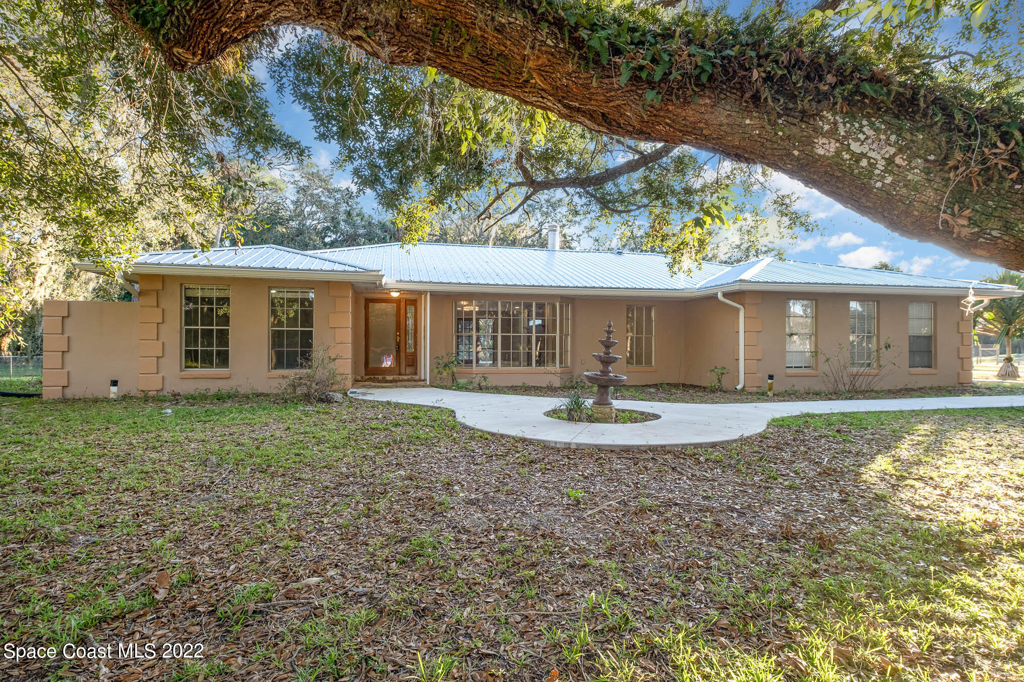 395 East Hall Road Merritt Island, FL 32953 - Photo 2 of 46 front view of a house with a yard