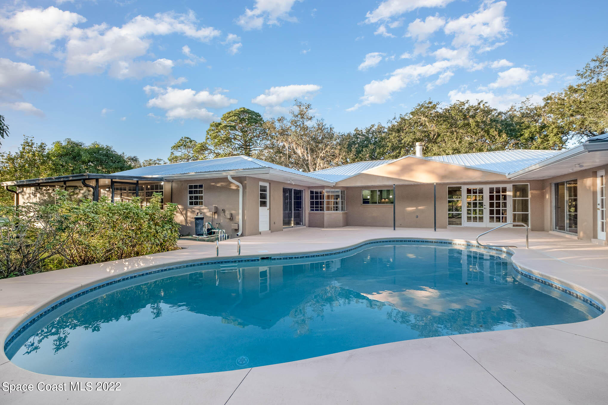 395 East Hall Road Merritt Island, FL 32953 - Photo 21 of 46 a view of house with swimming pool outdoor seating