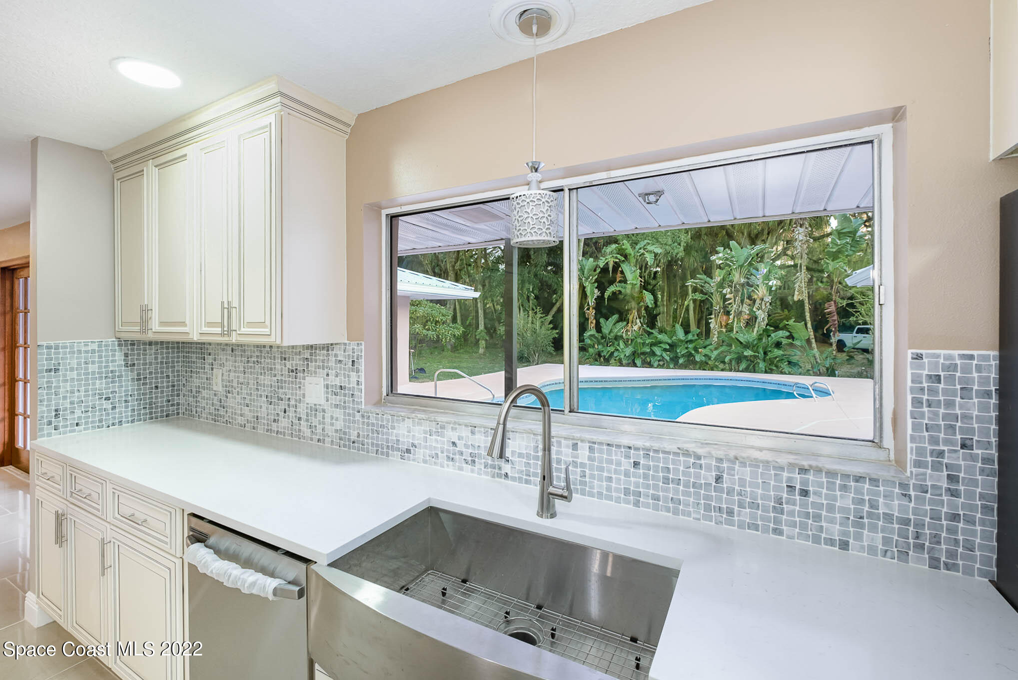 395 East Hall Road Merritt Island, FL 32953 - Photo 22 of 46 a kitchen with a sink and a large window