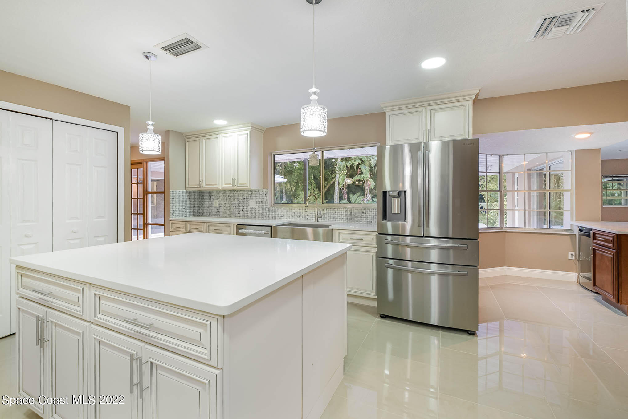 395 East Hall Road Merritt Island, FL 32953 - Photo 24 of 46 a kitchen with stainless steel appliances a refrigerator sink and cabinets