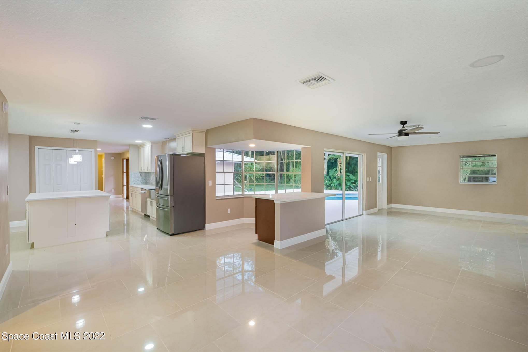 395 East Hall Road Merritt Island, FL 32953 - Photo 25 of 46 a view of a kitchen with furniture and floor to ceiling window