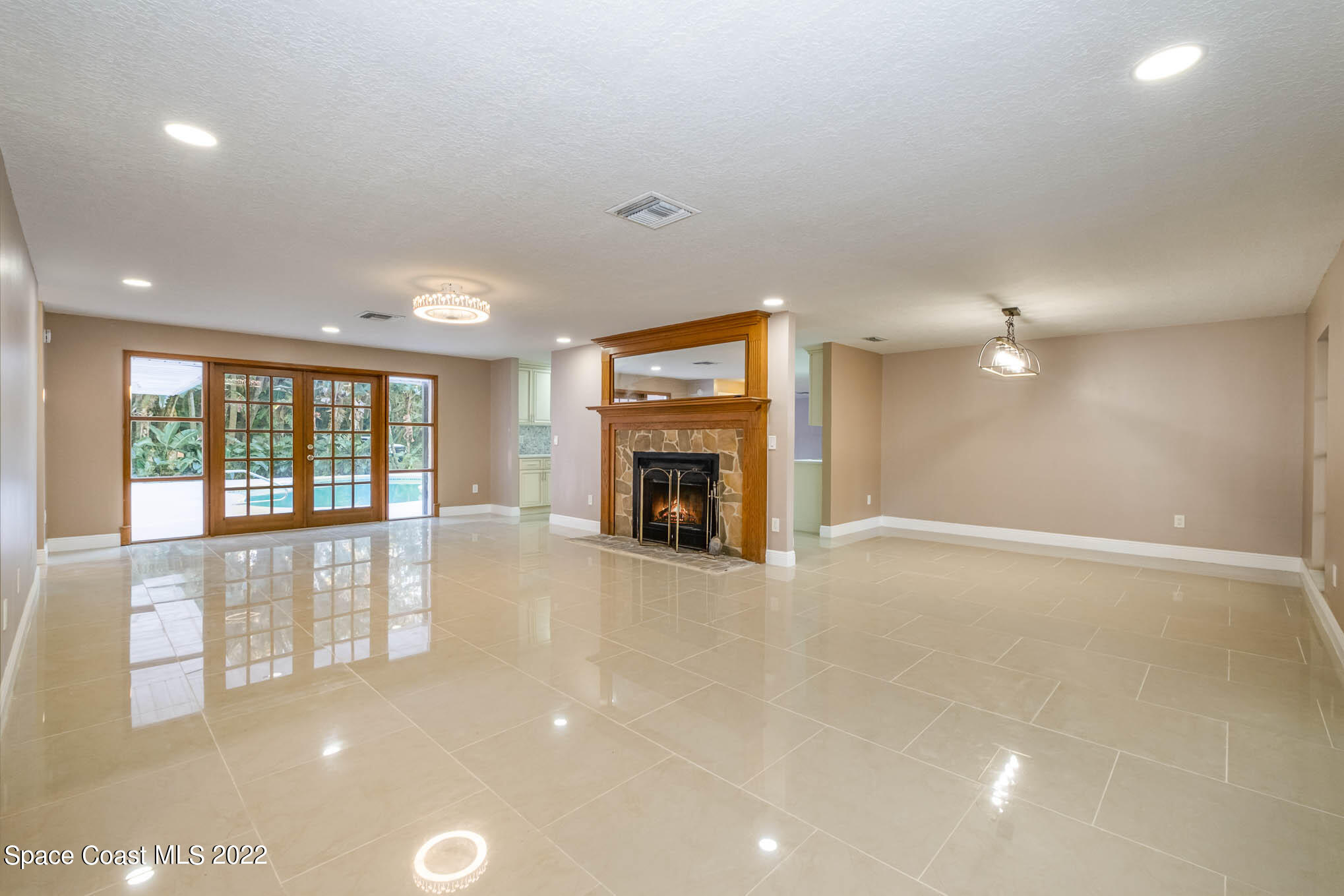395 East Hall Road Merritt Island, FL 32953 - Photo 26 of 46 a view of an empty room with a fireplace and a window