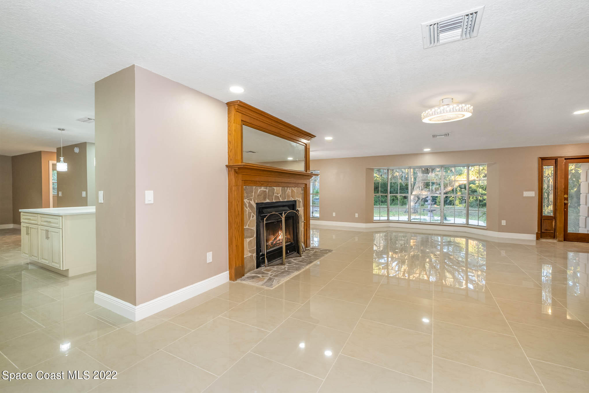 395 East Hall Road Merritt Island, FL 32953 - Photo 27 of 46 a view of an empty room with a fireplace and a large window