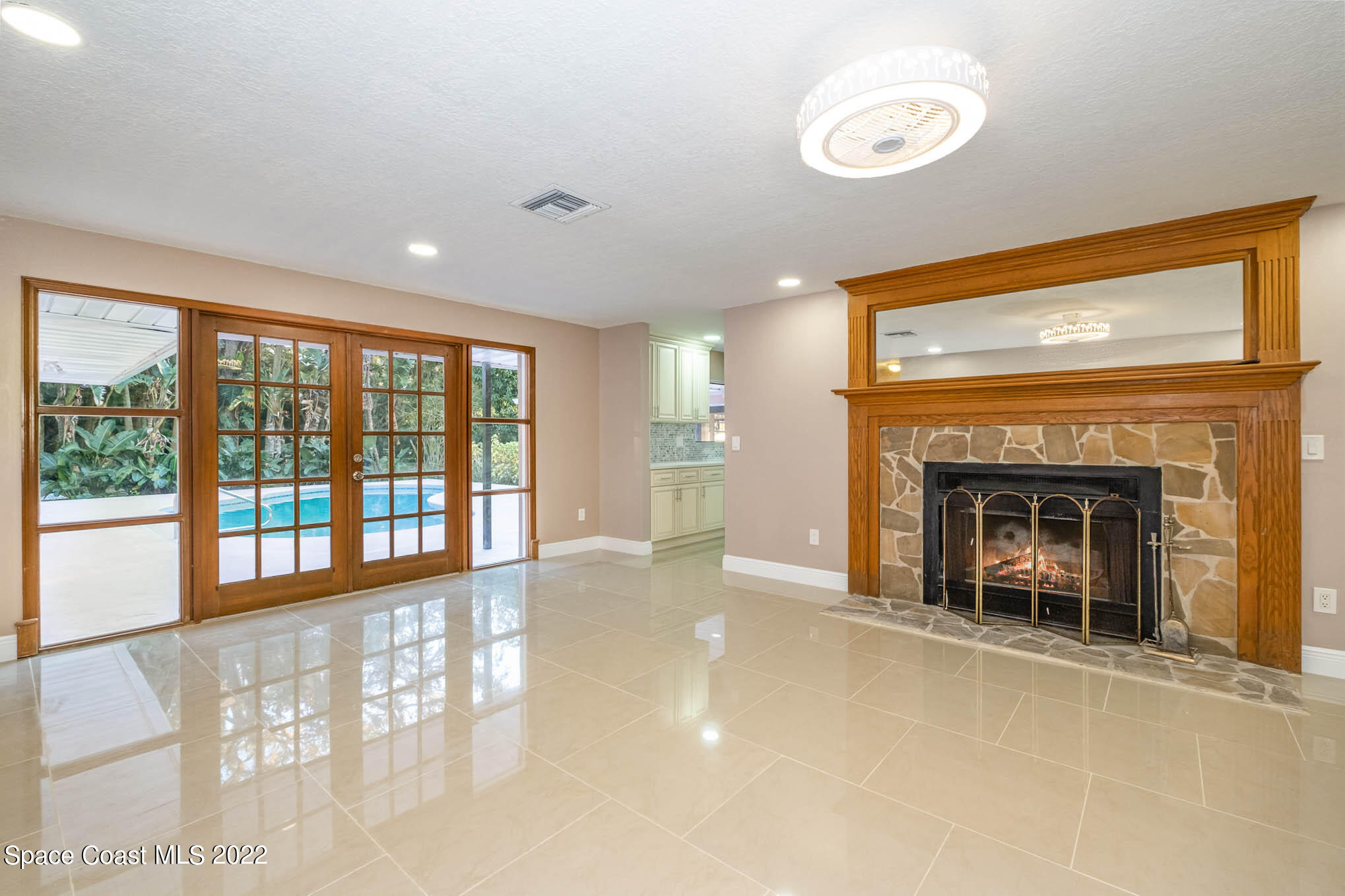 395 East Hall Road Merritt Island, FL 32953 - Photo 28 of 46 a view of an empty room with a fireplace and a window