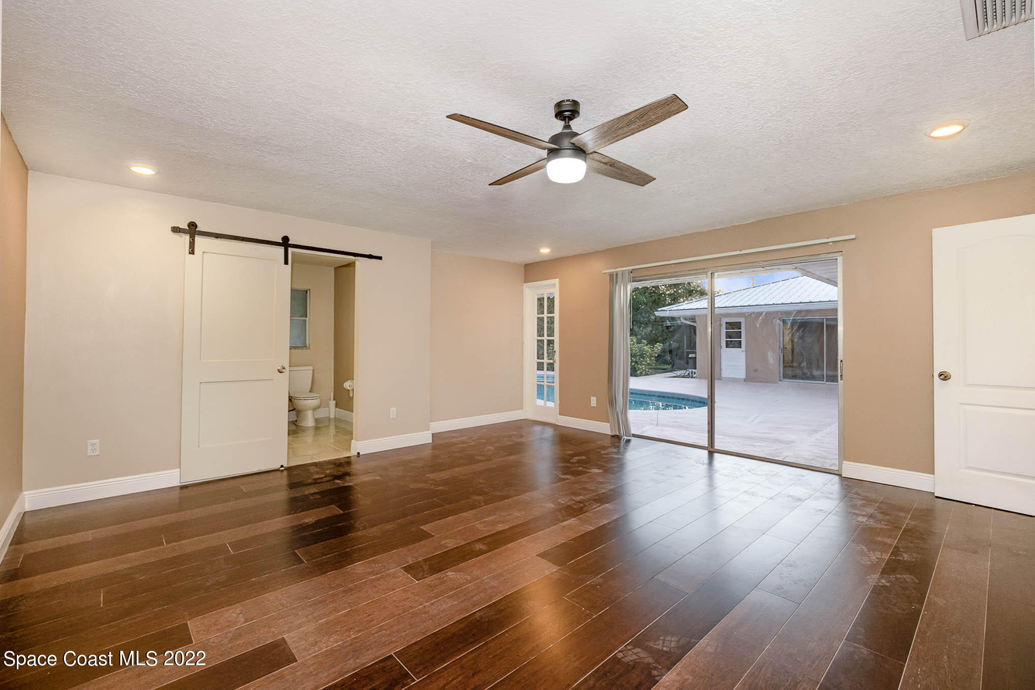 395 East Hall Road Merritt Island, FL 32953 - Photo 30 of 46 a view of an empty room with wooden floor and a window