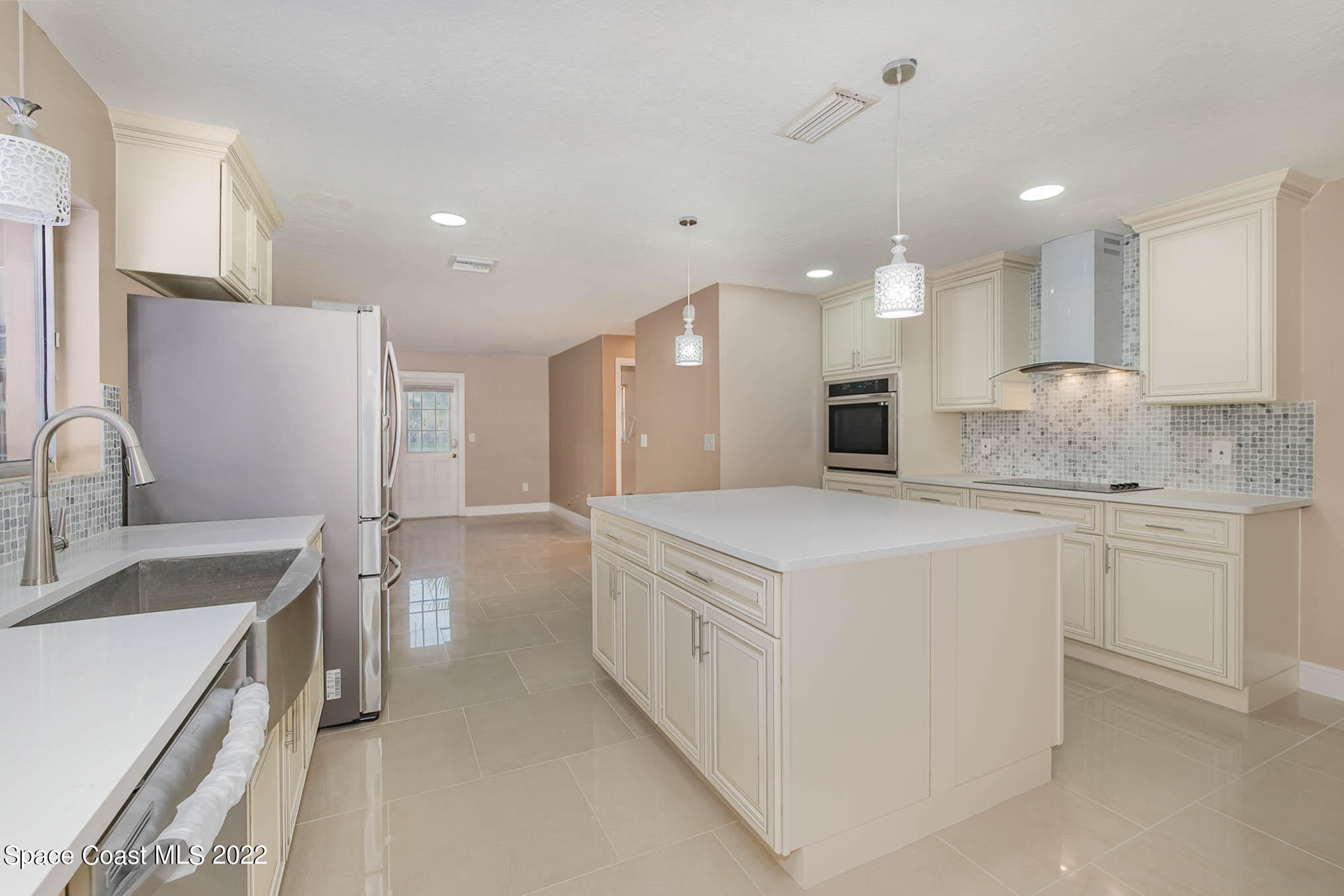 395 East Hall Road Merritt Island, FL 32953 - Photo 3 of 46 a large kitchen with kitchen island a sink stainless steel appliances and cabinets