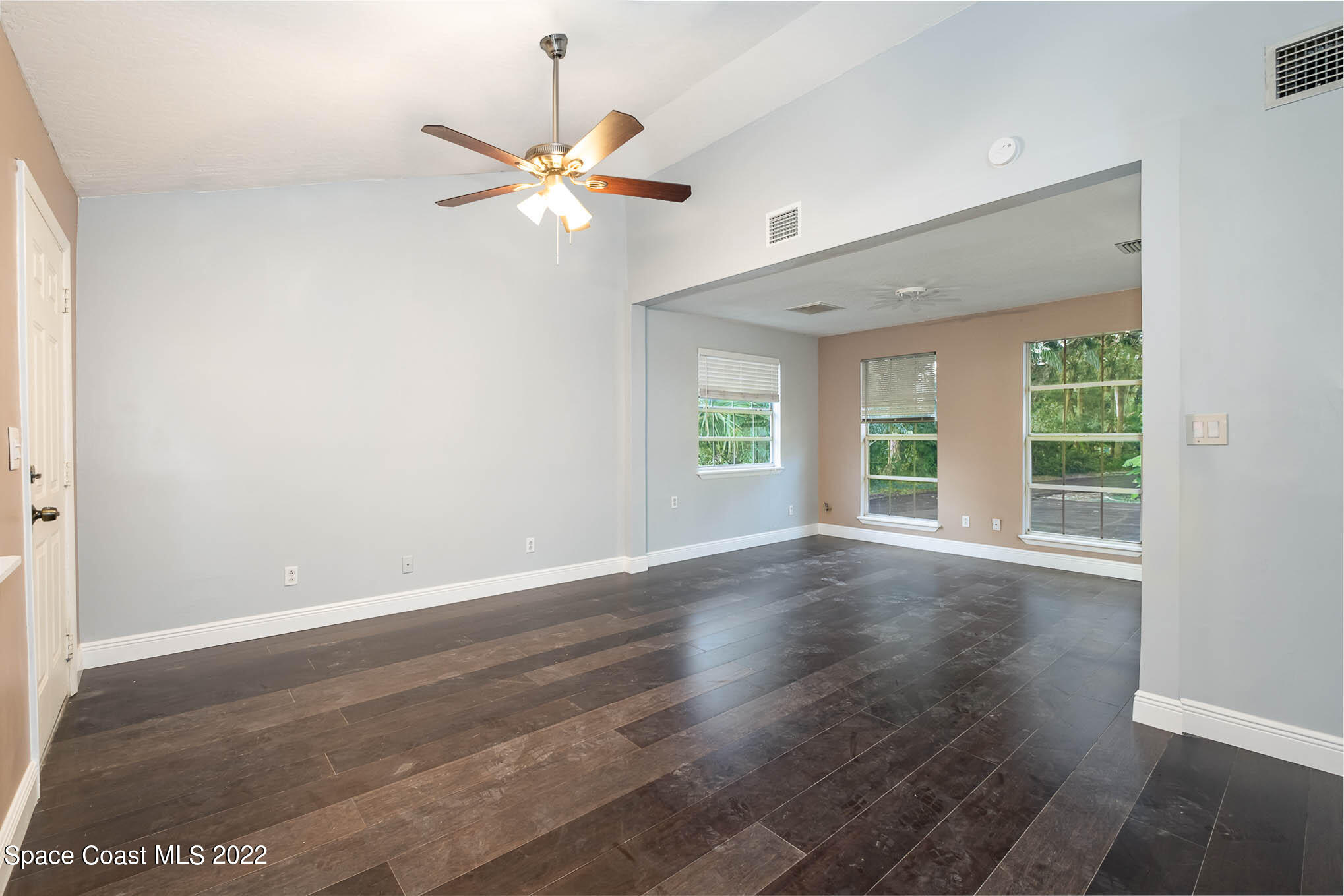 395 East Hall Road Merritt Island, FL 32953 - Photo 33 of 46 an empty room with wooden floor fan and windows
