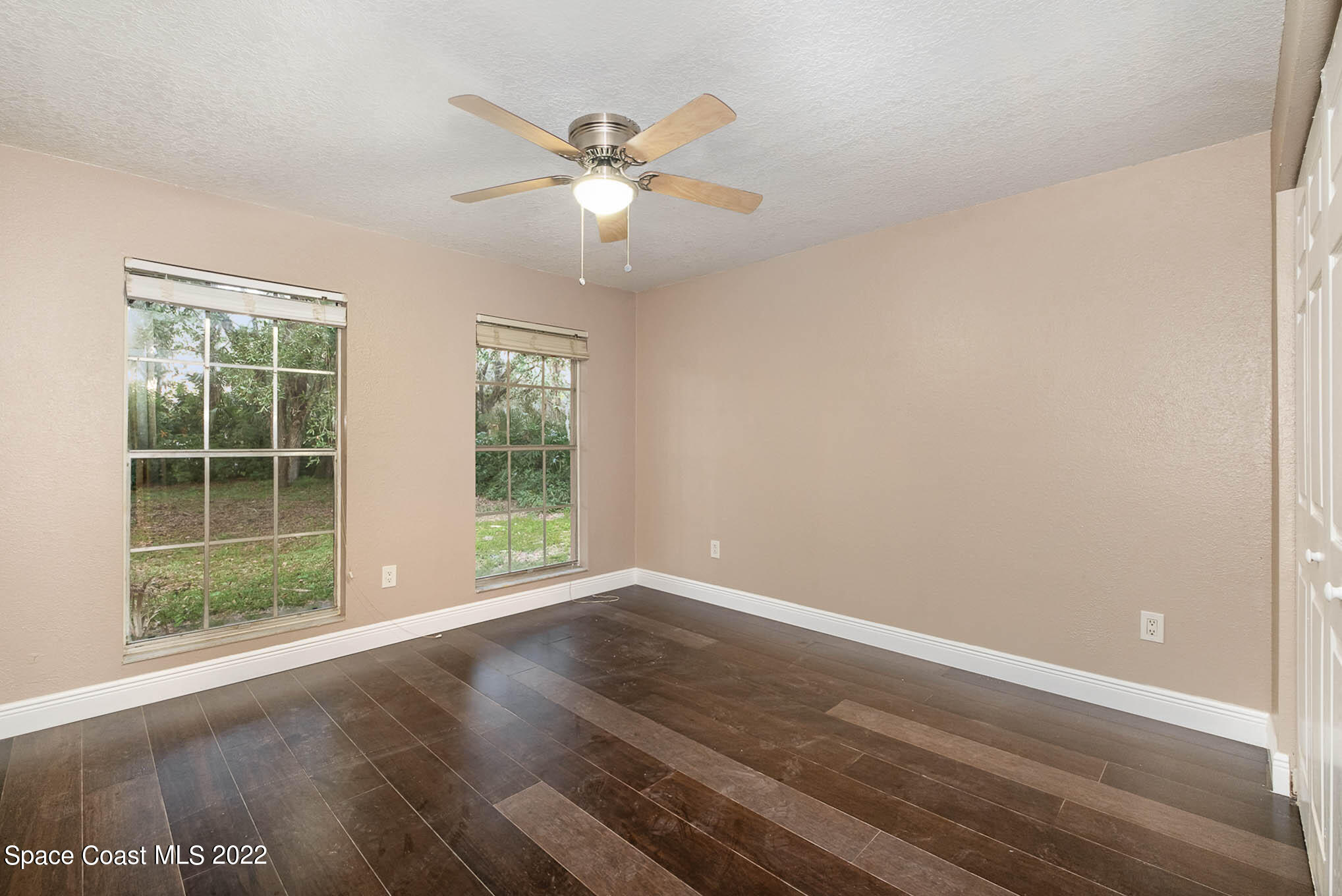 395 East Hall Road Merritt Island, FL 32953 - Photo 34 of 46 a view of an empty room with wooden floor and a window