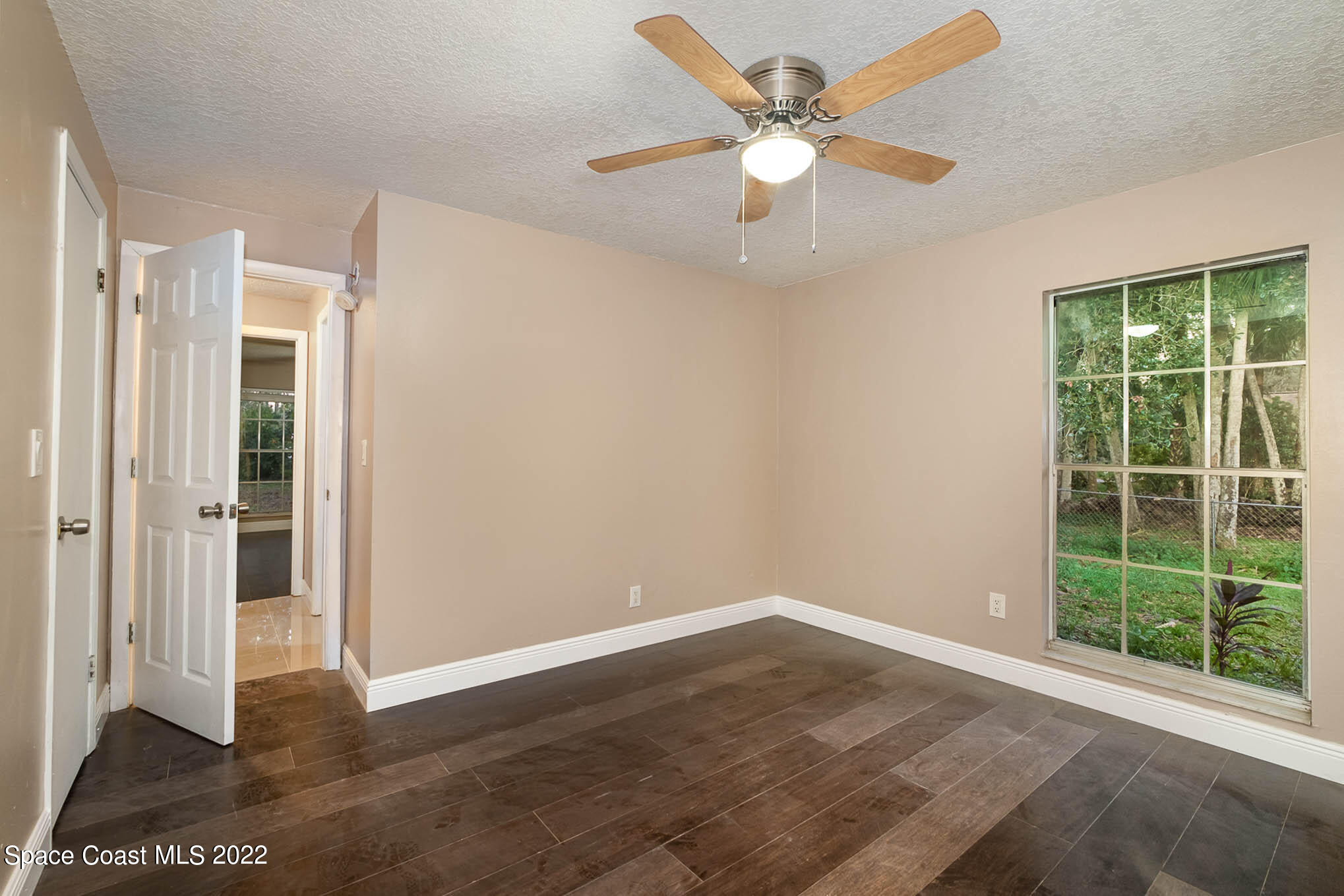 395 East Hall Road Merritt Island, FL 32953 - Photo 36 of 46 an empty room with wooden floor and window