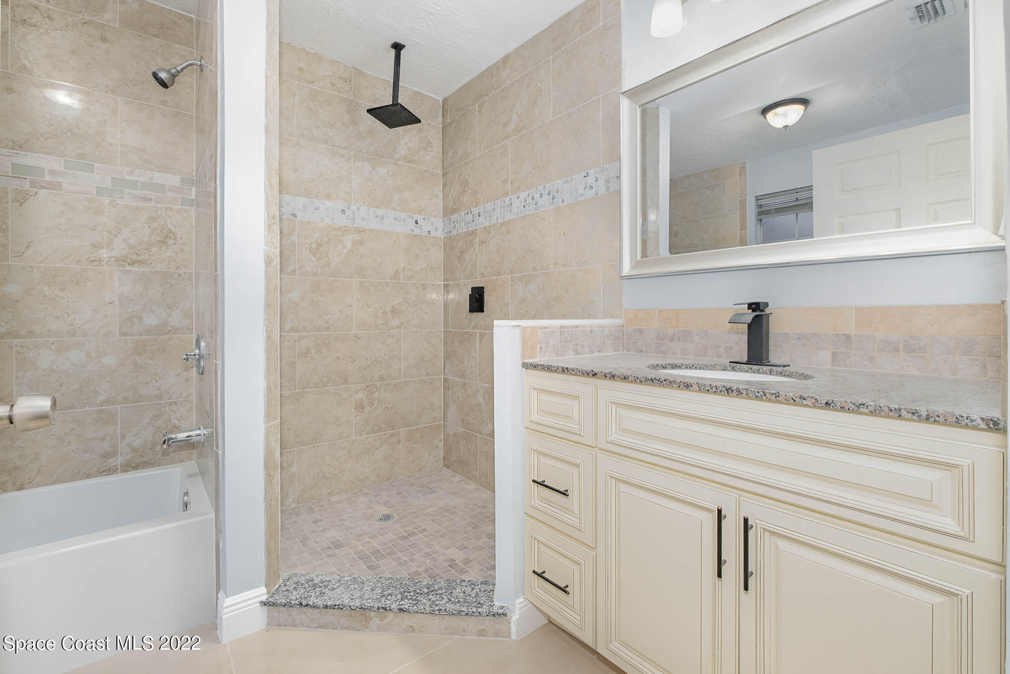 395 East Hall Road Merritt Island, FL 32953 - Photo 38 of 46 a bathroom with a sink a mirror and a bathtub