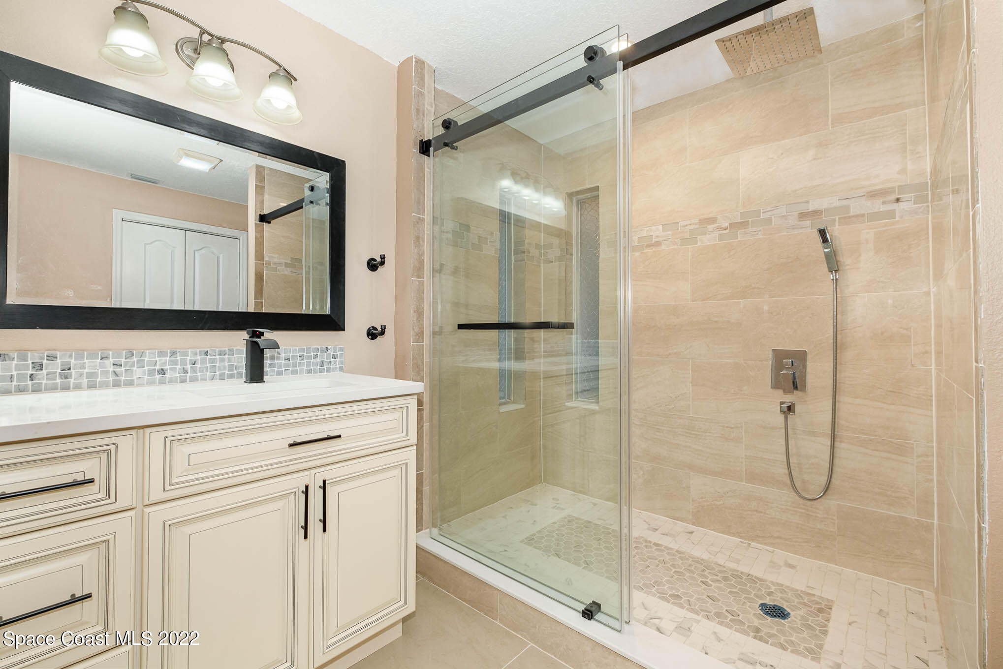 395 East Hall Road Merritt Island, FL 32953 - Photo 40 of 46 a bathroom with a shower sink and mirror