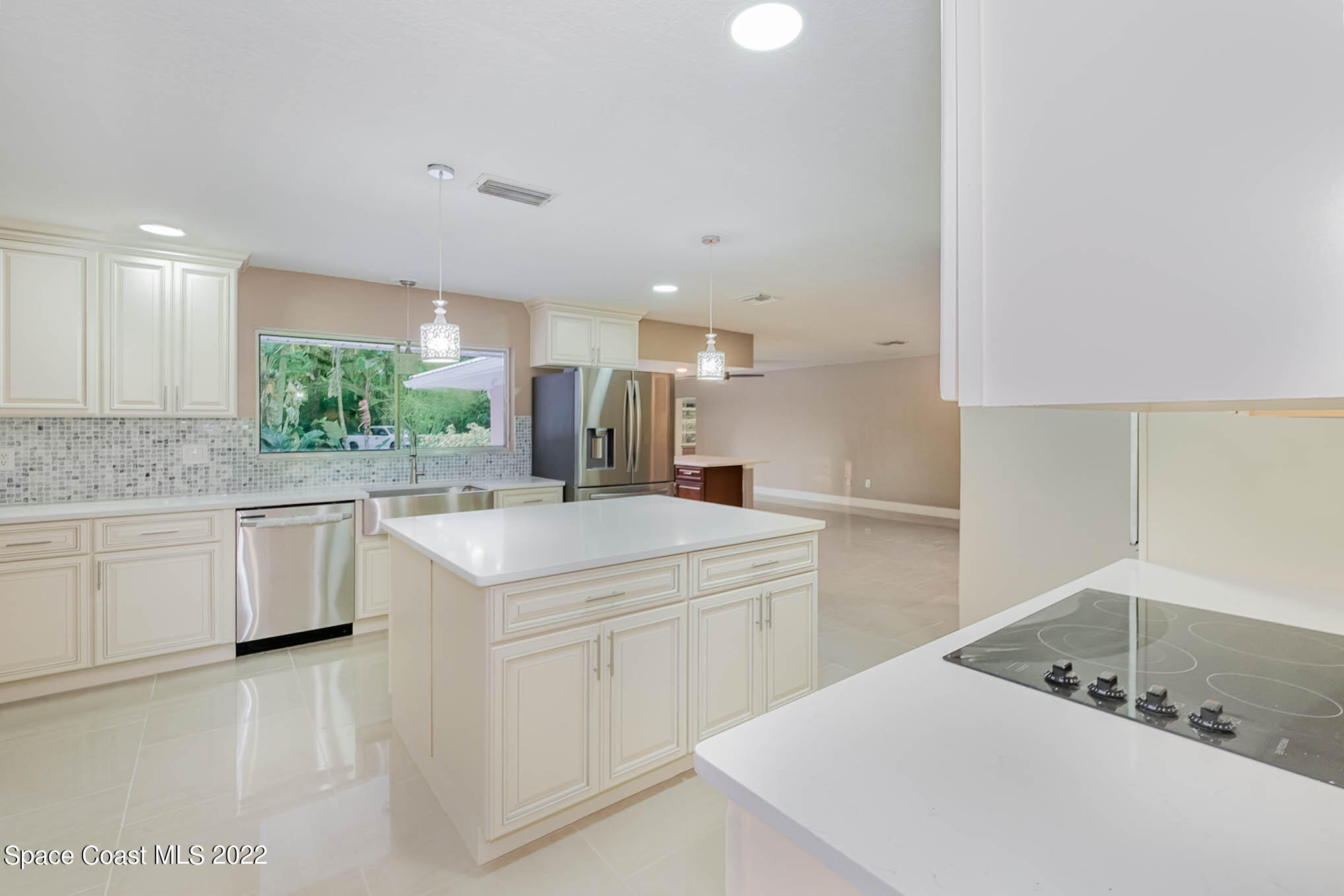395 East Hall Road Merritt Island, FL 32953 - Photo 4 of 46 a kitchen that has a sink and a stove in it