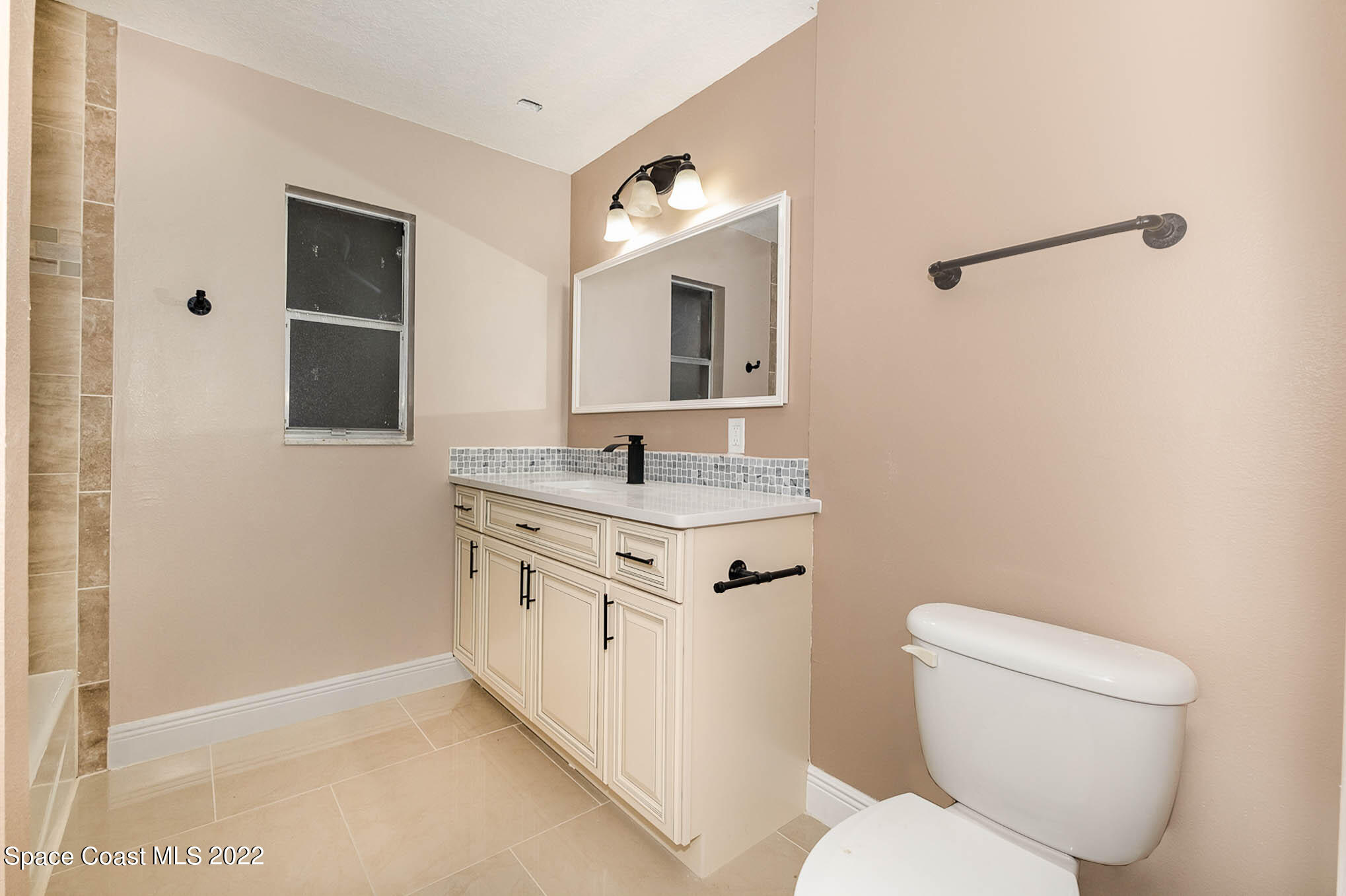 395 East Hall Road Merritt Island, FL 32953 - Photo 44 of 46 a bathroom with a granite countertop sink toilet and mirror