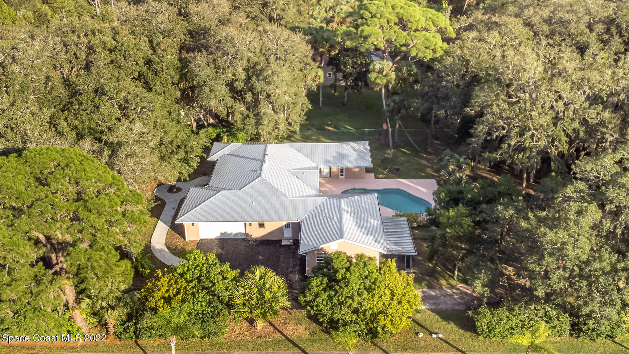 395 East Hall Road Merritt Island, FL 32953 - Photo 5 of 46 an aerial view of a house with a yard and garden
