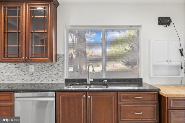 a view of a kitchen with a sink and cabinets