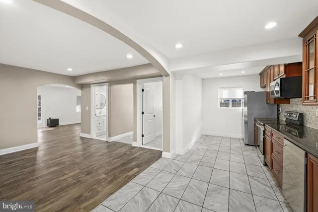 a kitchen with stainless steel appliances granite countertop a stove microwave and sink