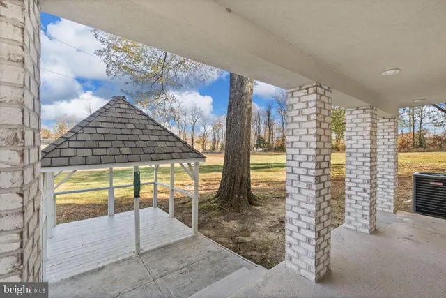 a front view of a house with a yard table and chairs
