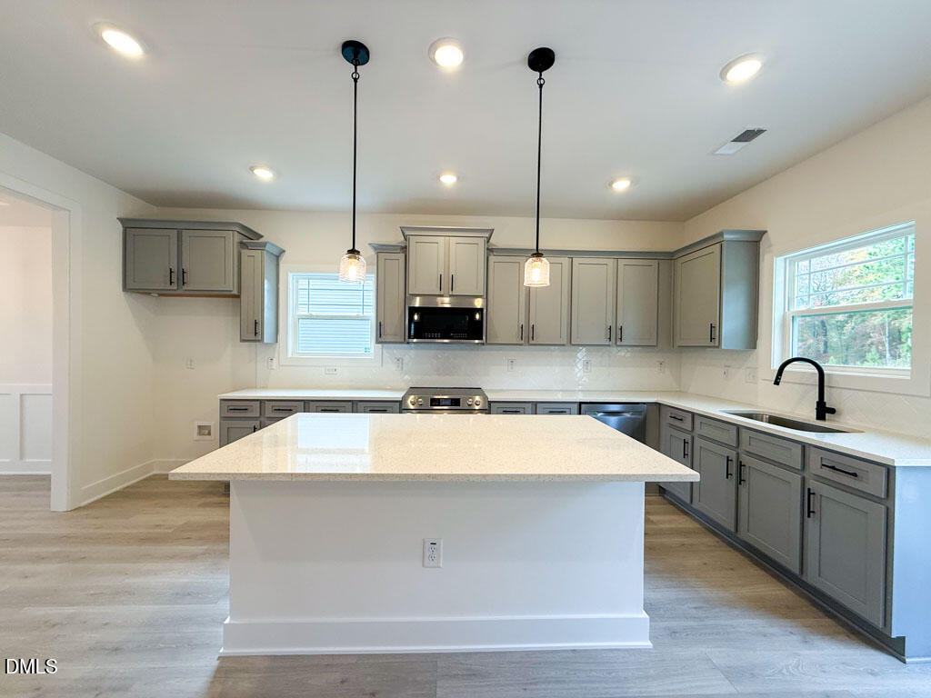 27 Decatur Drive Fuquay-Varina, NC 27526 - Photo 10 of 46 a large kitchen with kitchen island a sink stainless steel appliances and cabinets