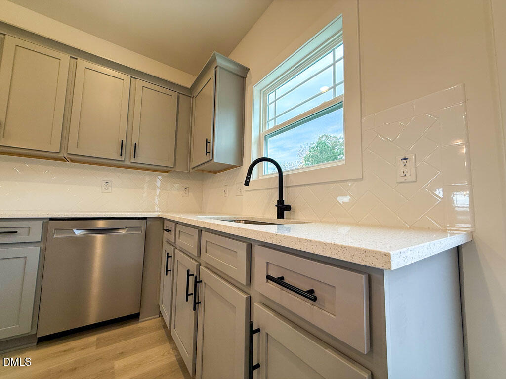 27 Decatur Drive Fuquay-Varina, NC 27526 - Photo 14 of 46 a kitchen with a sink cabinets and stainless steel appliances