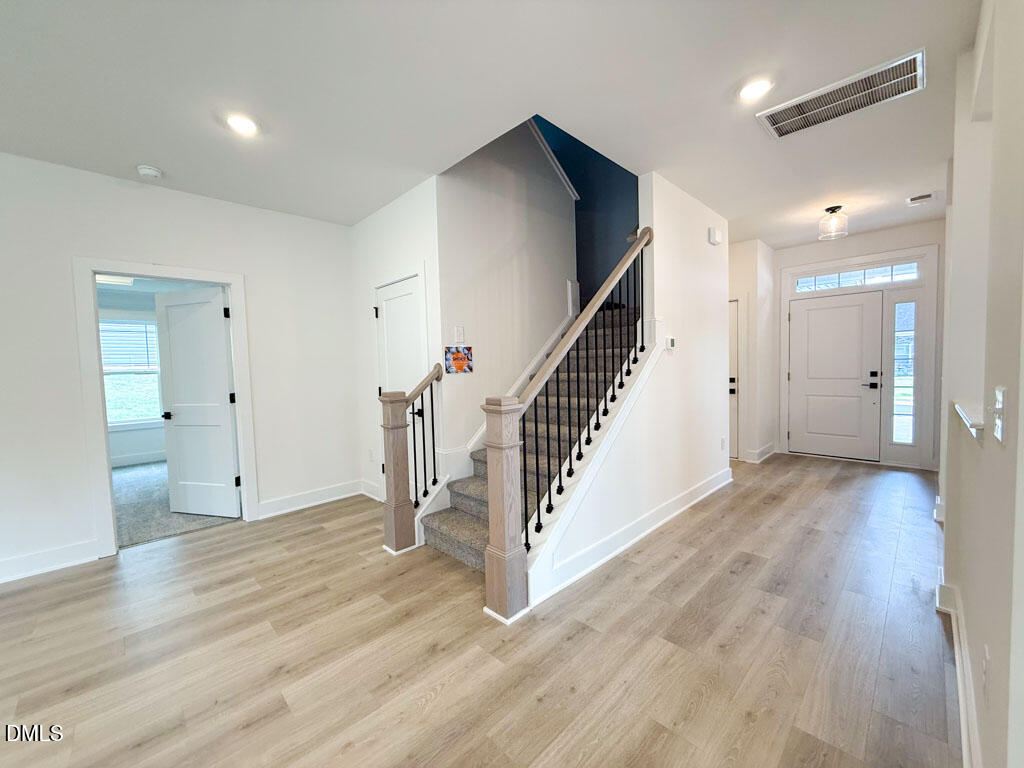 27 Decatur Drive Fuquay-Varina, NC 27526 - Photo 17 of 46 a view of entryway with wooden floor and staircase