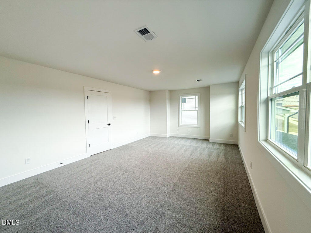 27 Decatur Drive Fuquay-Varina, NC 27526 - Photo 24 of 46 a view of empty room with windows and ceiling fan
