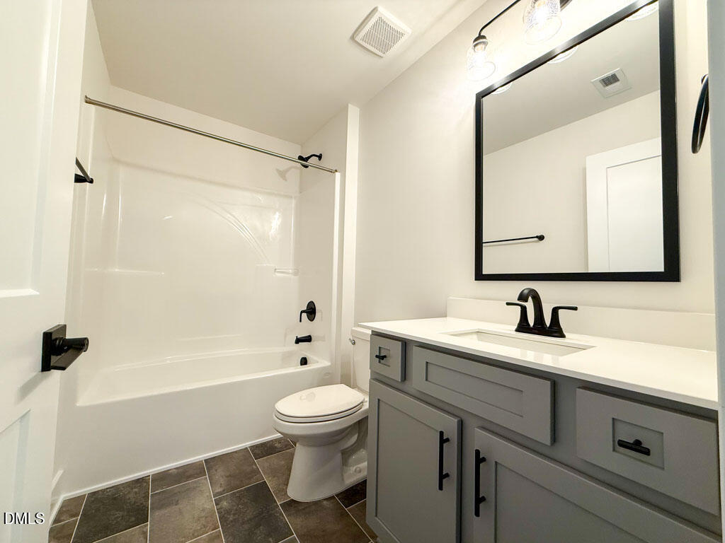 27 Decatur Drive Fuquay-Varina, NC 27526 - Photo 26 of 46 a bathroom with a sink a toilet and a mirror