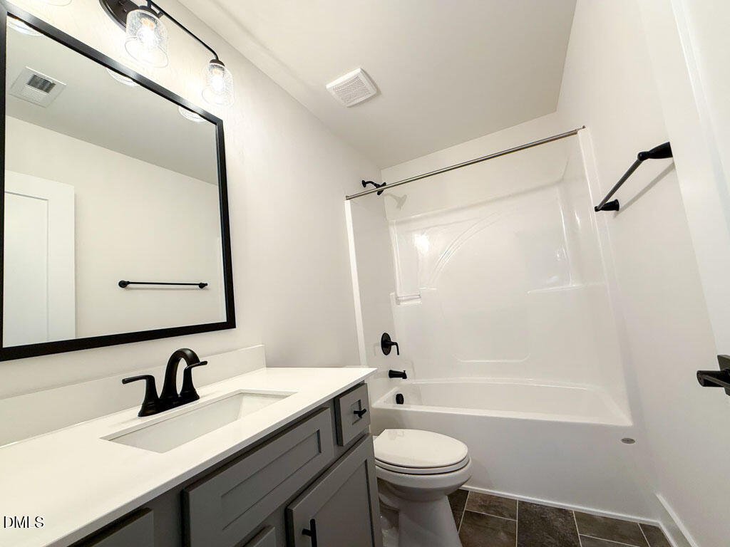 27 Decatur Drive Fuquay-Varina, NC 27526 - Photo 31 of 46 a bathroom with a sink mirror toilet and bathtub