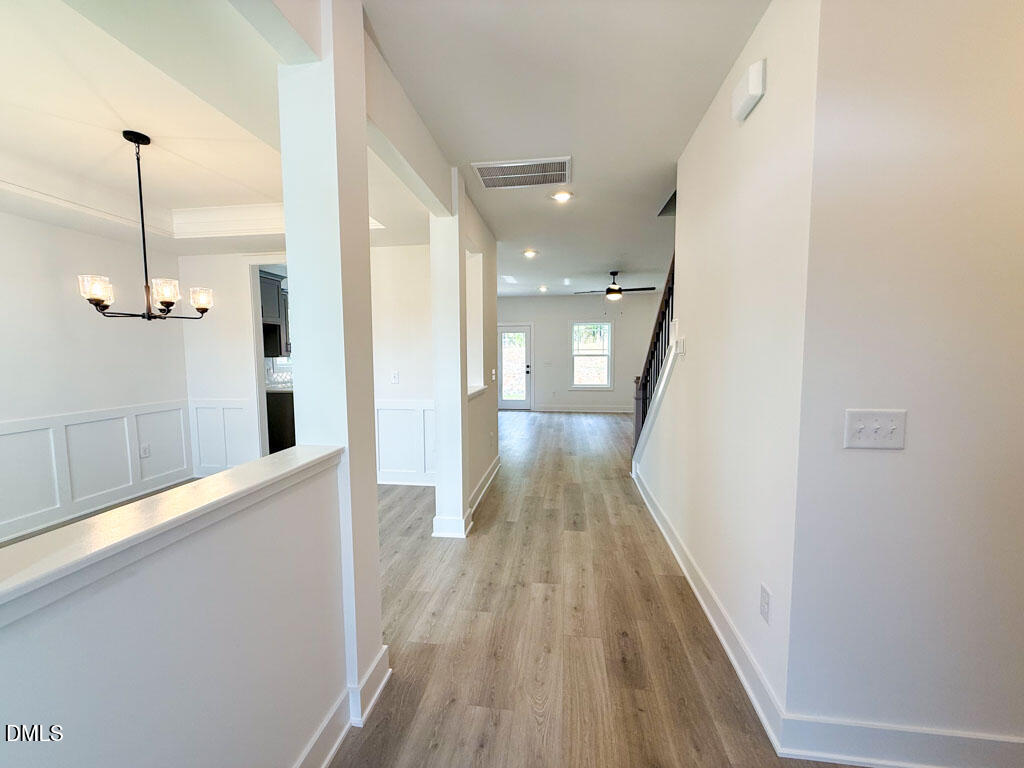 27 Decatur Drive Fuquay-Varina, NC 27526 - Photo 5 of 46 a view of a hallway with wooden floor and staircase