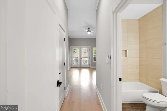 a bathroom with a bathtub shower sink vanity and toilet