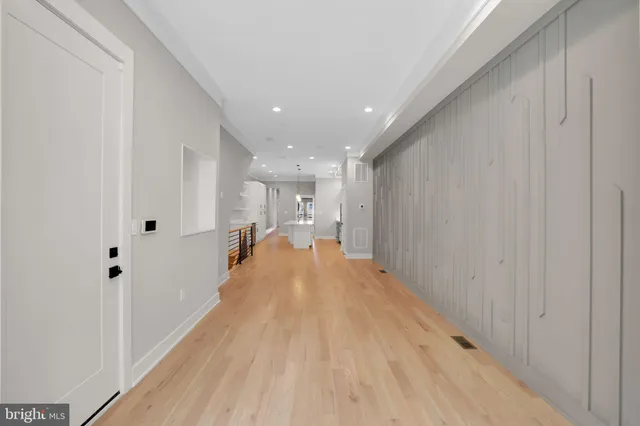 a view of a hallway with wooden floor