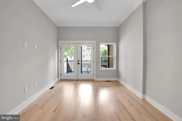wooden floor in an empty room with a window