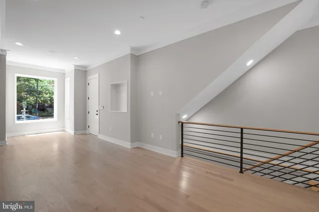 a view of a room with wooden floor and window