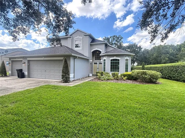 a front view of a house with a yard and garage