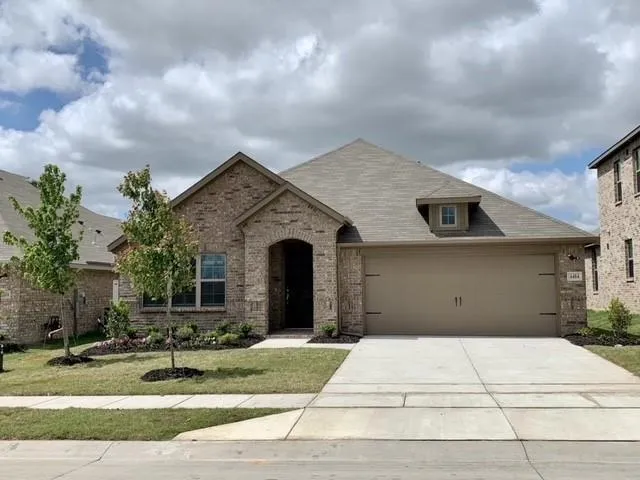 a view of a white house with a yard and plants