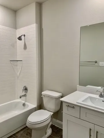 a view of a bedroom with wooden floor and hallway