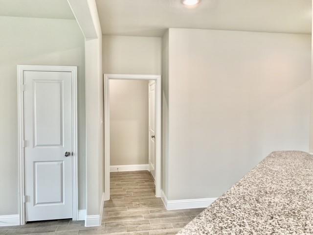 4404 Thalia Way Forney, TX 75126 - Photo 15 of 20 a view of a bedroom with wooden floor and hallway