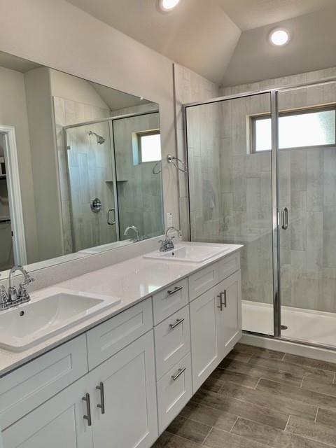 4404 Thalia Way Forney, TX 75126 - Photo 16 of 20 a bathroom with double vanity sinks and a shower