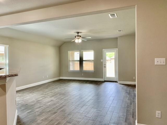 4404 Thalia Way Forney, TX 75126 - Photo 8 of 20 an empty room with wooden floor and windows