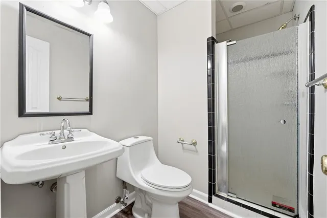 a bathroom with a sink toilet a mirror and shower